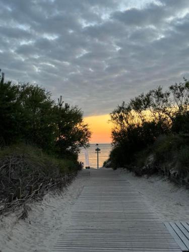 a pathway leading to the beach at sunset at SeasideSpa appartment Jakuzzi Swimming pool in Palanga