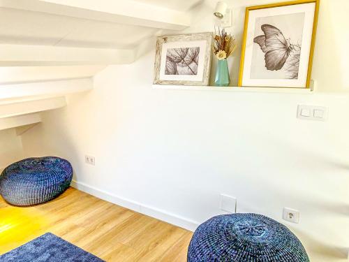 two blue ottomans in a living room with a staircase at Viveiro Dreams in Viveiro