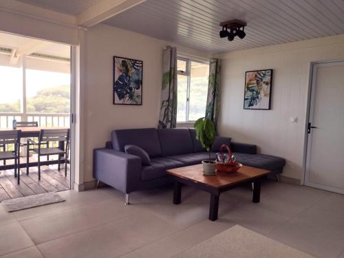 a living room with a couch and a table at Moorea - Atiha bay MH2 in Moorea
