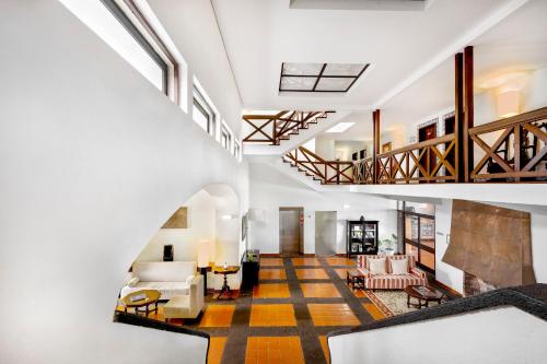 an open living room with a staircase and a lobby at Pousada Forte da Horta in Horta
