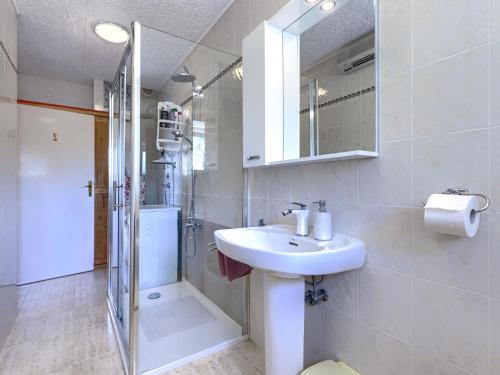 a bathroom with a sink and a shower at Apartment Bumbak by Interhome in Umag