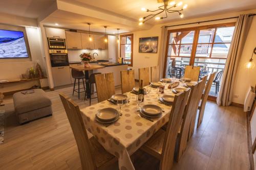 a dining room and kitchen with a table and chairs at Le Rioumajou 1 - Grand T6 - Piscine - Centre St Lary in Saint-Lary-Soulan