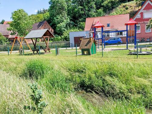 a park with a playground with a play equipment at Apartment An der Eine-1 by Interhome in Stangerode