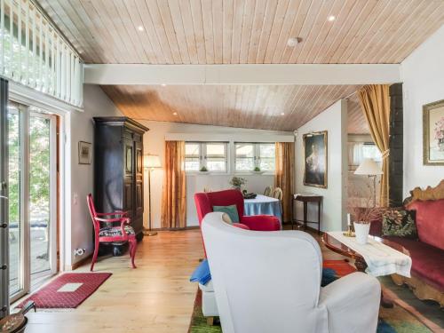 a living room with a couch and chairs at Chalet Rindö by Interhome in Vaxholm