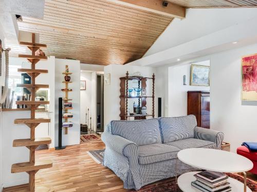a living room with a couch and a wooden ceiling at Chalet Rindö by Interhome in Vaxholm
