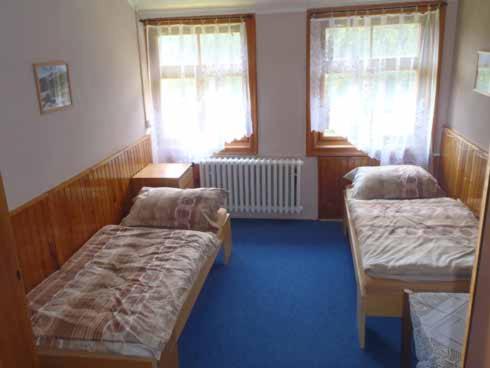 A bed or beds in a room at Horská chata Amor