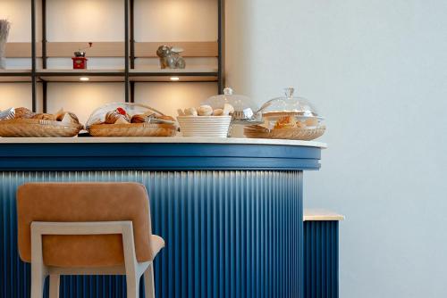 a counter with baskets of food on top of it at Fraser Suites Al Liwan in Manama