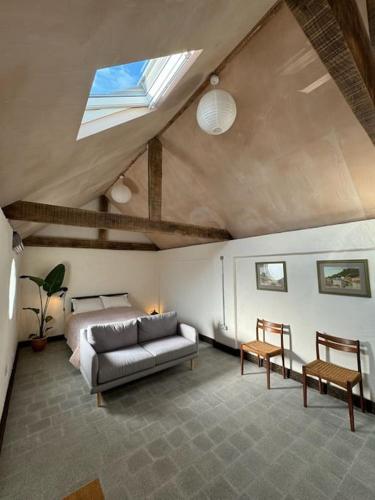 una sala de estar con un sofá y una cama en Cambridgeshire Wabi-sabi, en Barrington