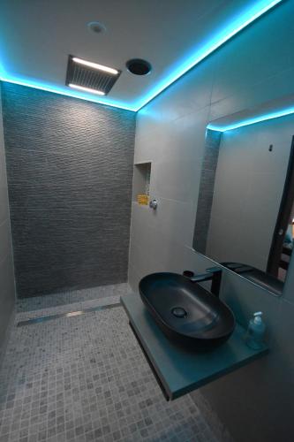 a bathroom with a black sink and a mirror at Luxury Non Smoking 2 bedroom retreat in Norfolk in Attleborough