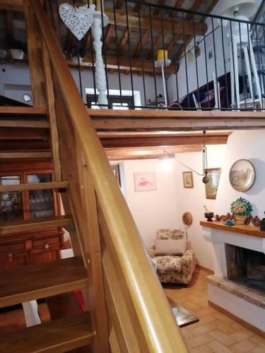 a spiral staircase in a room with a chair at La casa nel borgo in Orsogna
