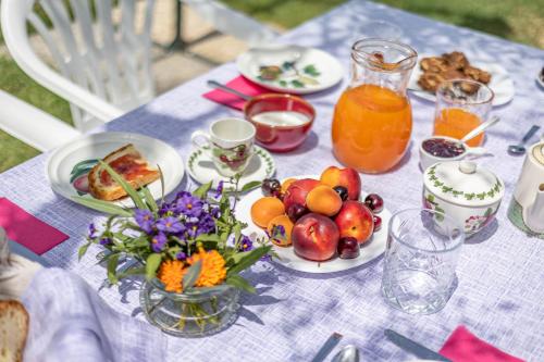 a table topped with plates of fruit and juice at Agriturimo Cà Dorale in Fano