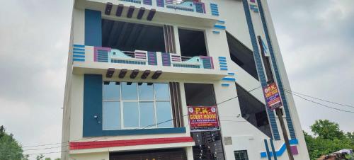 a building with blue and white windows and balconies at Hotel O Home PK Guest Homestay in Ayodhya