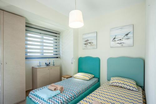 a bedroom with two beds with a stuffed animal on them at Apartments Enastron 44 2 bedroom in Pefkochori