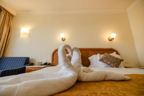 a swan made out of towels on a bed at Grand Court Hotel in Jerusalem