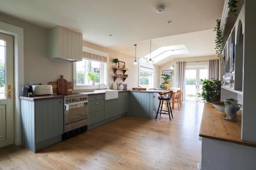a kitchen with blue cabinets and a table in it at The Lake Lodge in Killaloe