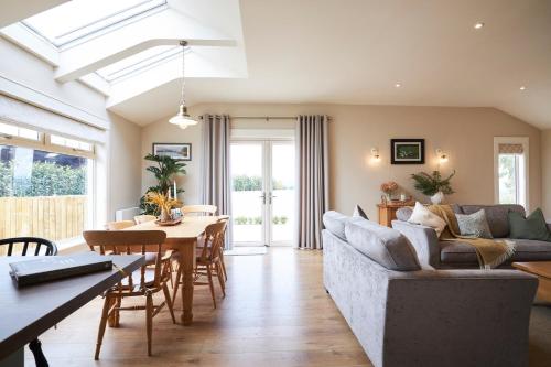 a living room with a couch and a table at The Lake Lodge in Killaloe