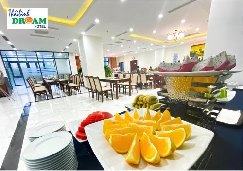 a restaurant with a plate of fruit on a table at Khách sạn Thái Bình Dream in Thái Bình