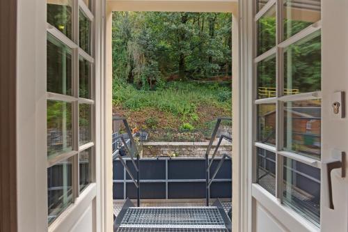 an open door to a patio with a view of a yard at Residenz Hugo in Bad Schandau