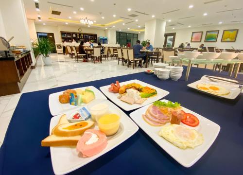 a table with three plates of food on it at Khách sạn Thái Bình Dream in Thái Bình