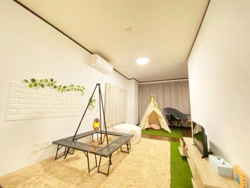 a living room with a table and a tent at THE MOON Atami in Atami