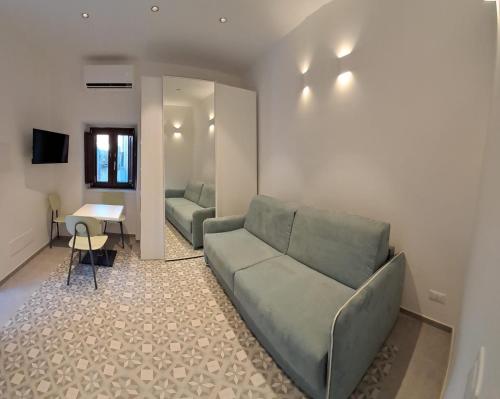 a living room with a couch and a table at Dolce-Giardino in Isnello