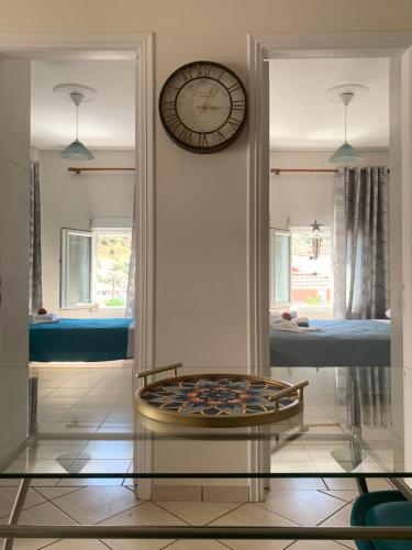 a room with a clock on the wall and a table at Aegean escape in Mytilini in Mytilene