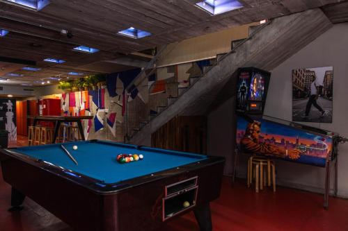 a room with a pool table and a staircase at Urbany Hostel BCN GO! in Barcelona