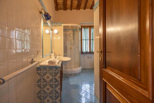 a bathroom with a sink and a shower and a mirror at Agriturimo Cà Dorale in Fano