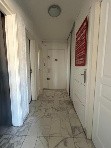 un couloir vide avec une porte et du carrelage dans l'établissement Chambre moderne chez l'habitant, à Toulon