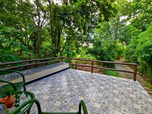 a bench sitting on a table in a garden at Tathastu Kanha in Kānha