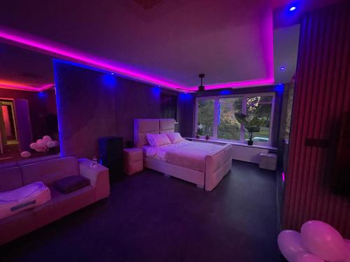 a bedroom with a bed and purple lights at Spartementen by Pure-Zen in Rotterdam
