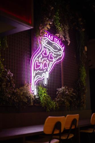 a neon sign that says taco max on a wall at JOST Hôtel Lille Centre in Lille