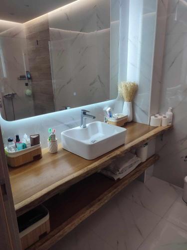 a bathroom with a white sink and a mirror at Lena Studios in Sidari