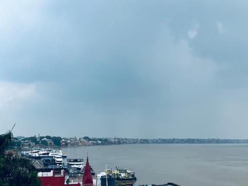 a view of a large body of water with boats at River view paying guest house in Varanasi