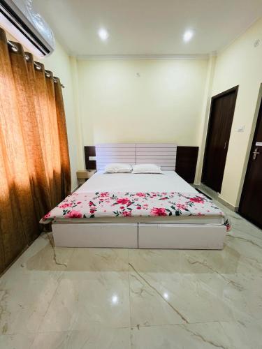 a bedroom with a bed with flowers on it at River view paying guest house in Varanasi