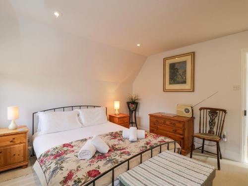 a bedroom with a bed with two candles on it at The Lodge in Quenington