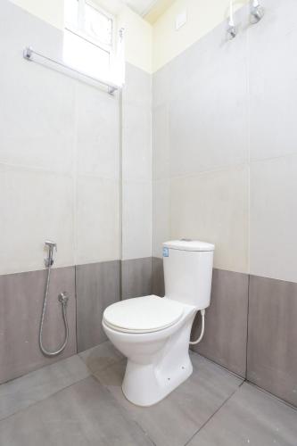 a bathroom with a toilet and a shower at Luxe Vue Appartment in Trivandrum
