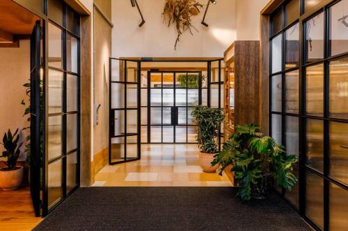 an open hallway with potted plants in a building at Luxury Apartments in a vibrant part of North London in London