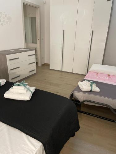 a bedroom with two beds and a dresser at Sweet home-Casa Di Bari in Turi