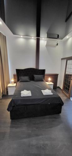 a bedroom with a large bed with two towels on it at Bumerang Apartmans, New Belgrade, Belgrade Arena in Belgrade
