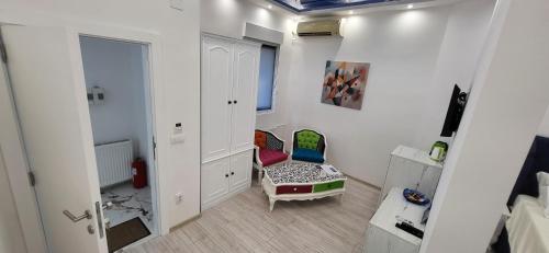 a white room with a chair and a mirror at Bumerang Apartmans, New Belgrade, Belgrade Arena in Belgrade