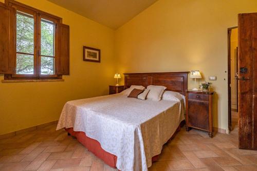 a bedroom with a bed in a yellow room at Agriturimo Cà Dorale in Fano