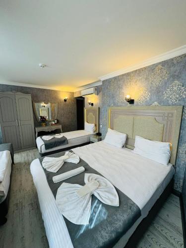 a hotel room with two beds with towels on them at Old City Viva Hotel in Istanbul