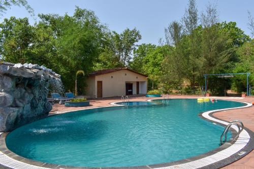 a large swimming pool with a water slide at Tathastu Kanha in Kānha