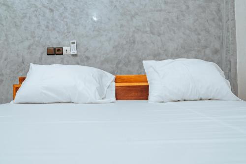 Postel nebo postele na pokoji v ubytování Hôtel Merveille Lomé