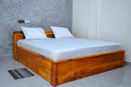 Postel nebo postele na pokoji v ubytování Hôtel Merveille Lomé