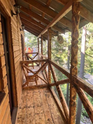 a view from the inside of a log cabin with a porch at Готель Згарда in Dragobrat