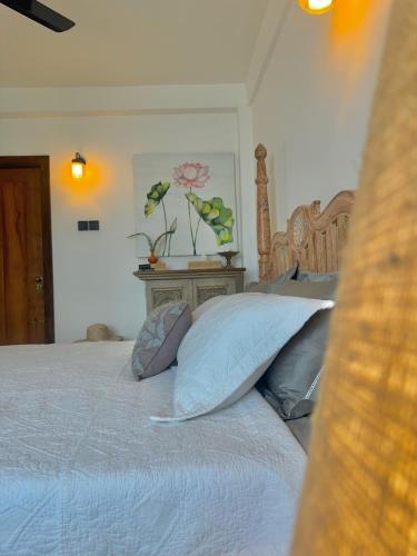 a bedroom with a bed with pillows on it at Villa Vikasa Colombo in Colombo