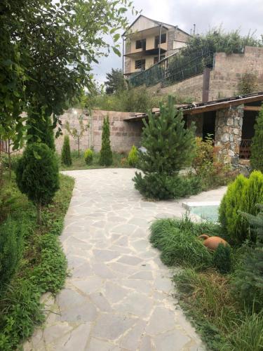 a garden with a stone walkway in front of a building at Villa Maria Dilijan in Dilijan