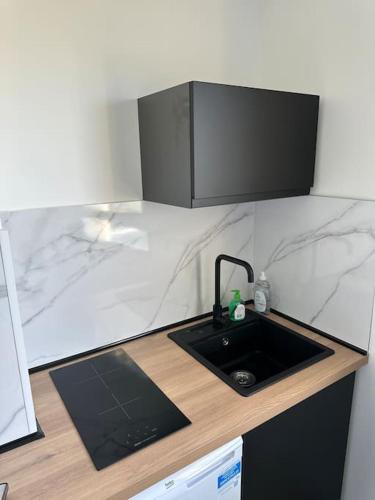 a kitchen with a sink and a counter top at Sea Side Calais vue mer in Calais